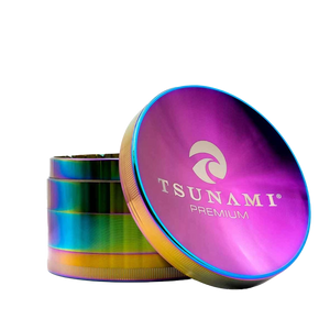 A large 100mm Tsunami herb grinder with a caved top and multiple chambers, displaying sharp diamond-cut teeth on a plain background.