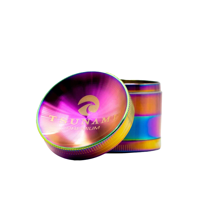 A silver 50mm Tsunami herb grinder with a caved top design, featuring diamond-cut teeth and a kief catcher.