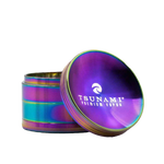 A 63mm Tsunami herb grinder with a distinctive caved top, showing its diamond-cut teeth and four-piece chamber design.