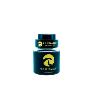 A 60mm Tsunami herb grinder with a clear glass storage jar attached, showing its multi-chamber design and sharp teeth.